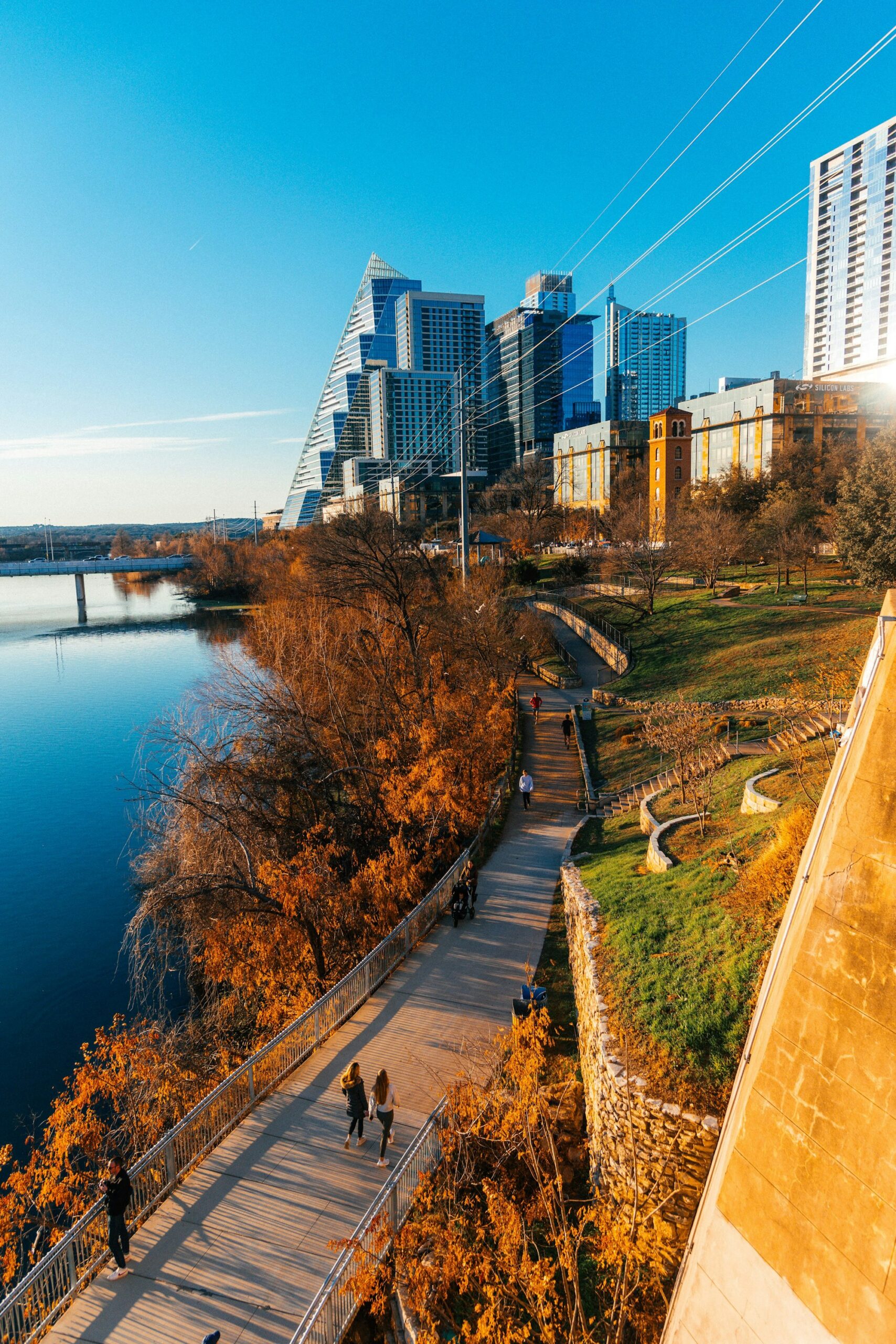 people walking along a path near a body of water